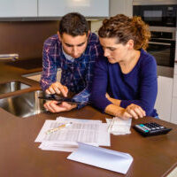 couple-managing-finances-in-kitchen